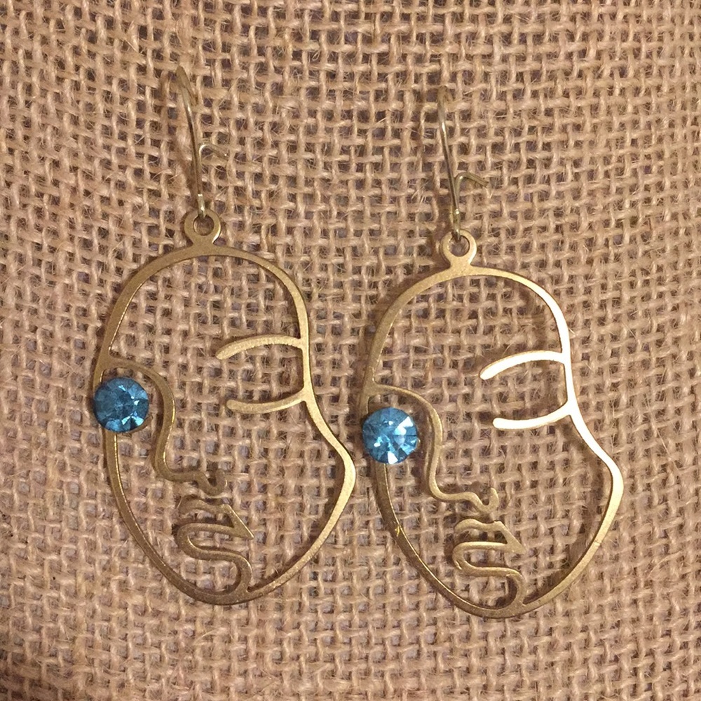 Gold face earrings